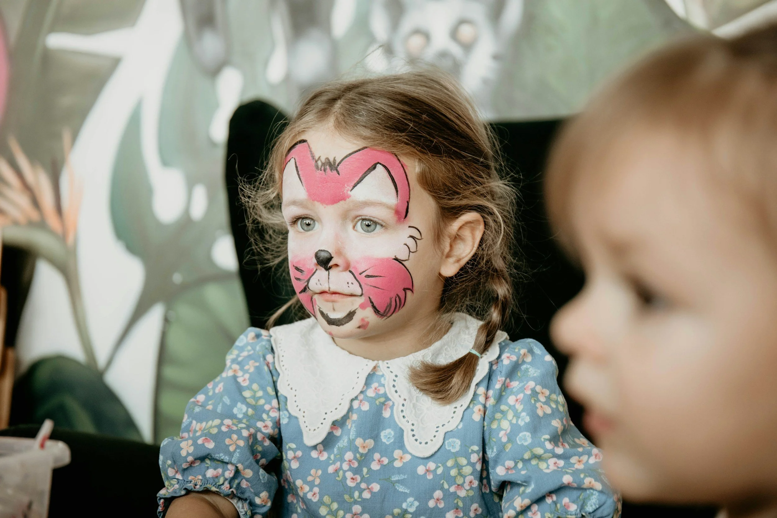 Girl with face paint at Mabel & Grace party
